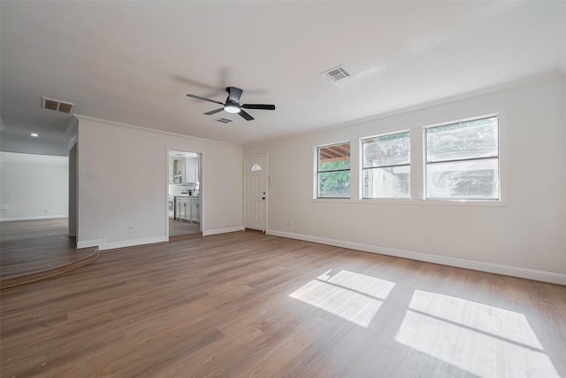8014 Wray Ct, Houston, TX 77088 - unfurnished room featuring a ceiling fan, baseboards, light wood finished floors, and ornamental molding
