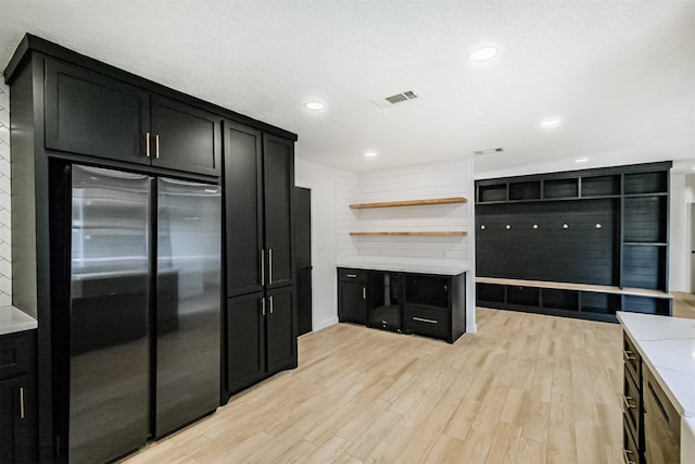 150 Squires Bnd, Stafford, TX 77477 - kitchen featuring freestanding refrigerator, dark cabinetry, open shelves, light wood-style flooring, and recessed lighting