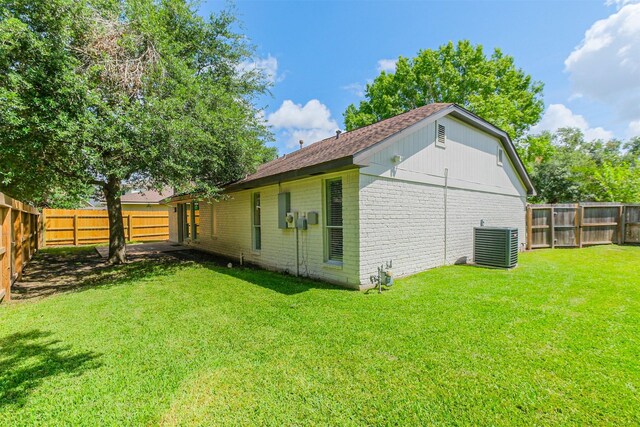 150 Squires Bnd, Stafford, TX 77477 - rear view of house with brick siding, cooling unit, and a shingled roof