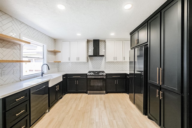 150 Squires Bnd, Stafford, TX 77477 - kitchen featuring stainless steel appliances, open shelves, wall chimney range hood, a sink, and white cabinets