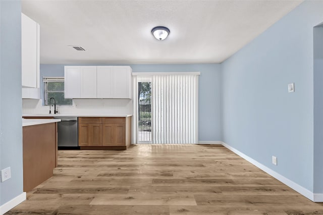 627 Edgebrook Dr, Houston, TX 77034 - kitchen with stainless steel dishwasher, plenty of natural light, light countertops, and light wood-style flooring