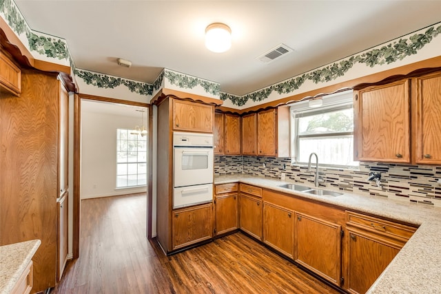 6310 Ash Oak Dr, Houston, TX 77091 - kitchen with a sink, oven, a warming drawer, light countertops, and dark wood finished floors