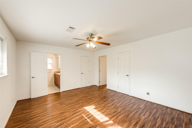 6310 Ash Oak Dr, Houston, TX 77091 - unfurnished bedroom with wood finished floors, ensuite bath, baseboards, and a ceiling fan