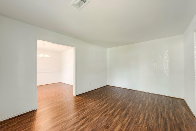 6310 Ash Oak Dr, Houston, TX 77091 - empty room featuring a chandelier, dark wood finished floors, and baseboards