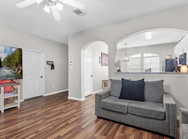 1202 Travis St, La Porte, TX 77571 - living area featuring wood finished floors, a ceiling fan, arched walkways, and baseboards