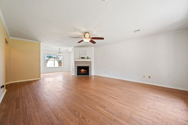 4309 Kingfish Dr, Seabrook, TX 77586 - unfurnished living room featuring a ceiling fan, wood finished floors, crown molding, a tiled fireplace, and baseboards