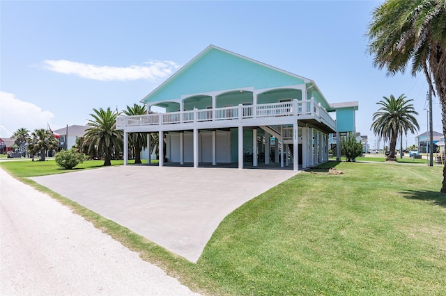 2585 Tide Dr, Crystal Beach, TX 77650 - raised beach house with a carport, concrete driveway, and a front yard