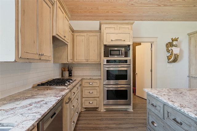 2585 Tide Dr, Crystal Beach, TX 77650 - kitchen with appliances with stainless steel finishes, dark wood-type flooring, light brown cabinets, decorative backsplash, and light stone counters