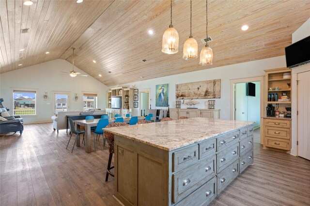 2585 Tide Dr, Crystal Beach, TX 77650 - kitchen with wooden ceiling, lofted ceiling, wood finished floors, a breakfast bar, and a chandelier