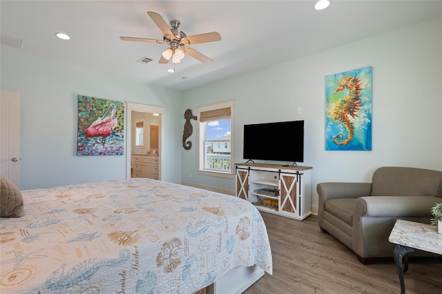 2585 Tide Dr, Crystal Beach, TX 77650 - bedroom with wood finished floors, recessed lighting, baseboards, ceiling fan, and ensuite bathroom