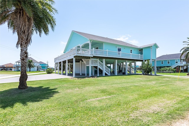 2585 Tide Dr, Crystal Beach, TX 77650 - view of front facade featuring stairway, a front lawn, and a carport