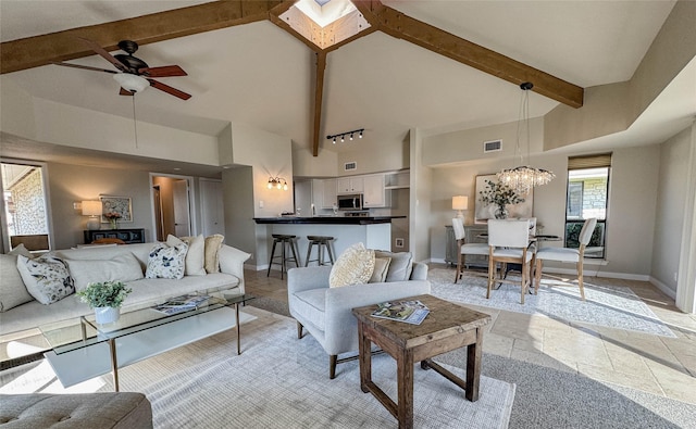 1406 Broken Hls Unit 14, Horseshoe Bay, TX 78657 - living room featuring high vaulted ceiling, a ceiling fan, baseboards, beam ceiling, and a chandelier