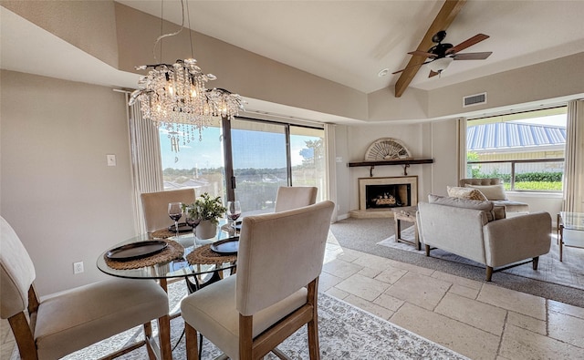 1406 Broken Hls Unit 14, Horseshoe Bay, TX 78657 - dining room with stone tile floors, a chandelier, a fireplace with raised hearth, ceiling fan, and baseboards