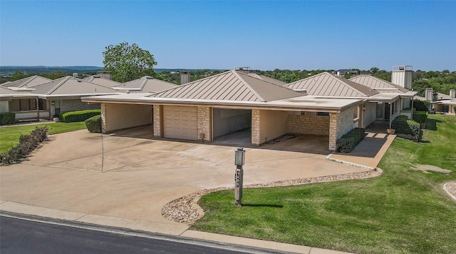 1406 Broken Hls Unit 14, Horseshoe Bay, TX 78657 - view of front of house with a standing seam roof, an attached garage, a front yard, concrete driveway, and metal roof