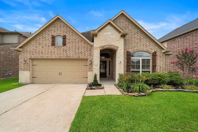19119 Cardinal Grove Ct, Cypress, TX 77429 - french country home featuring stone siding, brick siding, driveway, and a front yard