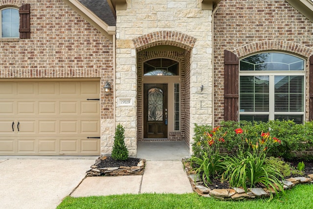 19119 Cardinal Grove Ct, Cypress, TX 77429 - view of exterior entry with concrete driveway, brick siding, stone siding, and a garage