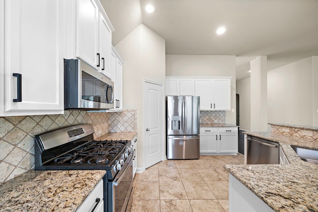 19119 Cardinal Grove Ct, Cypress, TX 77429 - kitchen with stainless steel appliances, white cabinetry, light stone countertops, backsplash, and recessed lighting