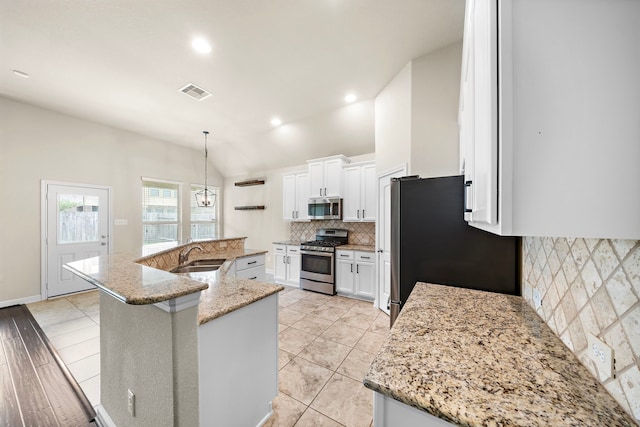 19119 Cardinal Grove Ct, Cypress, TX 77429 - kitchen with stainless steel appliances, a spacious island, tasteful backsplash, white cabinets, and light stone counters