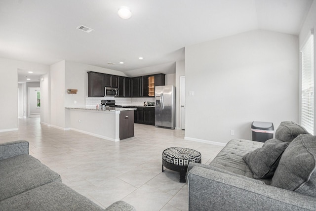 607 Harvest Bluff Dr, Rosharon, TX 77583 - living room with light tile patterned floors, recessed lighting, baseboards, and lofted ceiling
