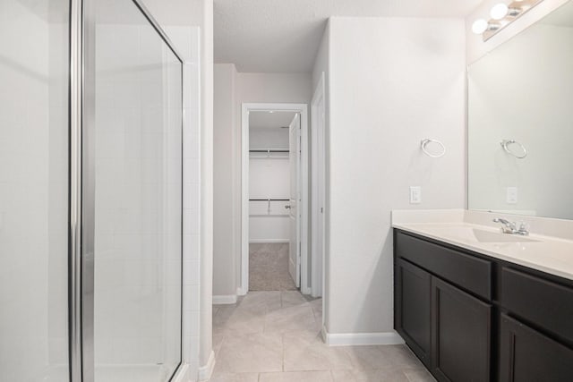 607 Harvest Bluff Dr, Rosharon, TX 77583 - bathroom featuring a shower stall, a spacious closet, baseboards, and vanity