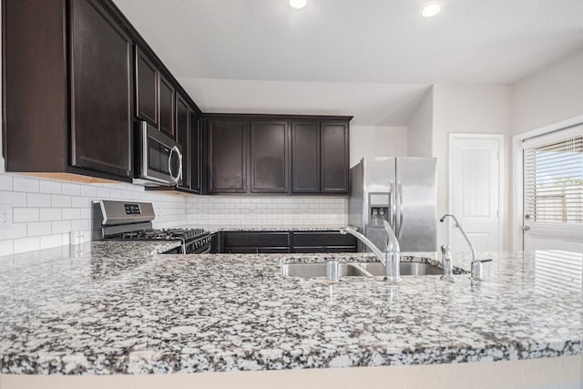 607 Harvest Bluff Dr, Rosharon, TX 77583 - kitchen featuring stainless steel appliances, a sink, light stone counters, backsplash, and recessed lighting