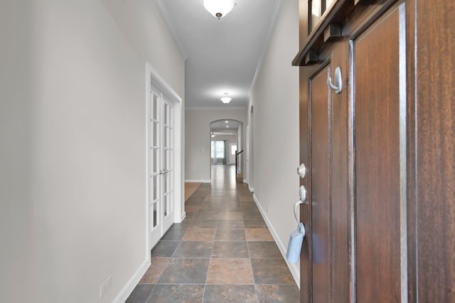 16819 Apple River Dr, Cypress, TX 77433 - hall with arched walkways, baseboards, crown molding, and dark stone finish flooring