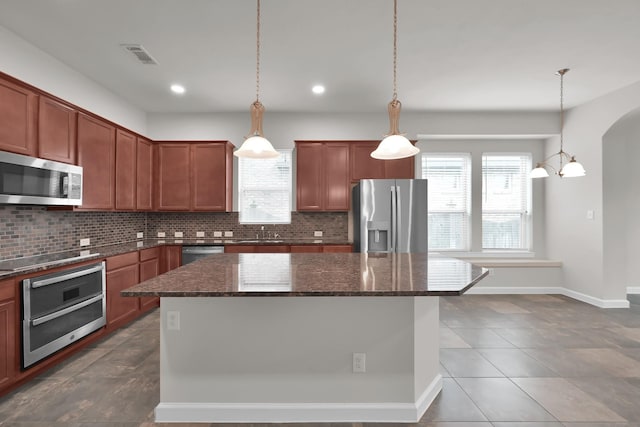 16819 Apple River Dr, Cypress, TX 77433 - kitchen with stainless steel appliances, backsplash, a kitchen island, dark stone countertops, and recessed lighting