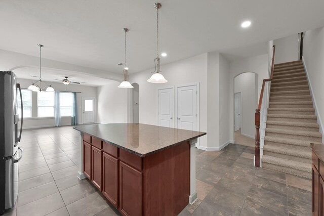 16819 Apple River Dr, Cypress, TX 77433 - kitchen with freestanding refrigerator, arched walkways, a center island, baseboards, and open floor plan