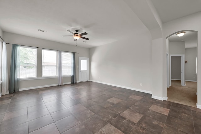 16819 Apple River Dr, Cypress, TX 77433 - unfurnished room with arched walkways, a ceiling fan, and baseboards