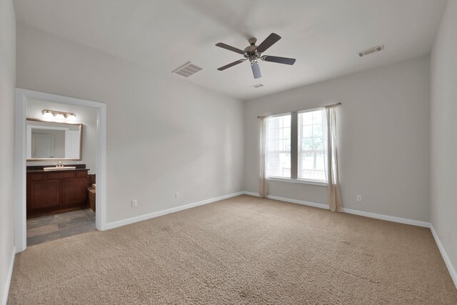 16819 Apple River Dr, Cypress, TX 77433 - unfurnished bedroom with light carpet, baseboards, a sink, connected bathroom, and a ceiling fan