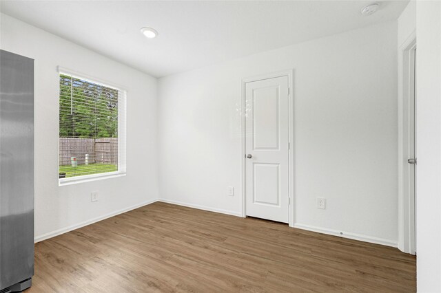 24027 Wandering Brook Dr, Hockley, TX 77447 - unfurnished room with wood finished floors, baseboards, and a smoke detector