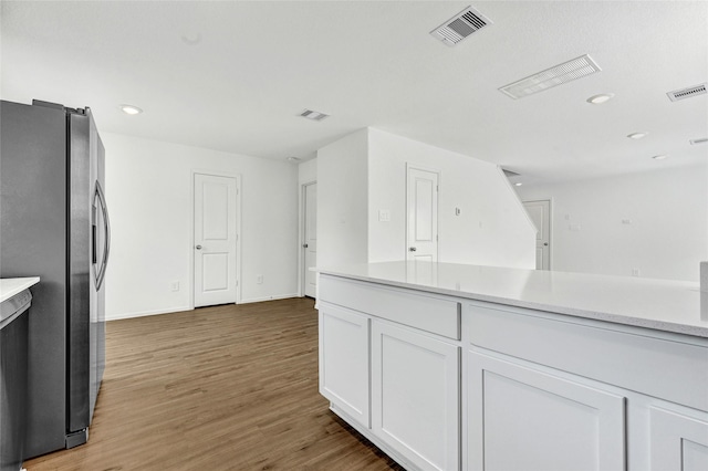 24027 Wandering Brook Dr, Hockley, TX 77447 - kitchen with freestanding refrigerator, white cabinets, light countertops, wood finished floors, and recessed lighting