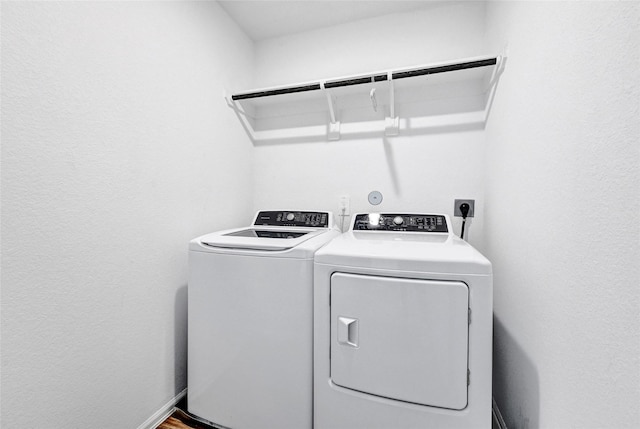 24027 Wandering Brook Dr, Hockley, TX 77447 - laundry room with separate washer and dryer and a textured wall