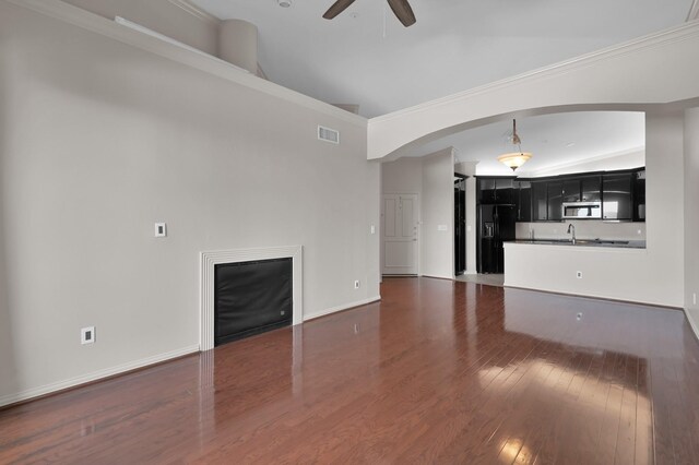 2100 Welch St Unit C309, Houston, TX 77019 - unfurnished living room featuring ceiling fan, dark wood-style flooring, and arched walkways