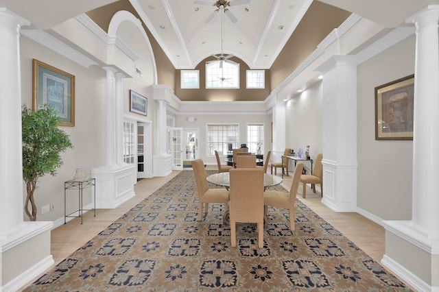 2100 Welch St Unit C309, Houston, TX 77019 - dining room featuring decorative columns, ceiling fan, light wood finished floors, and high vaulted ceiling