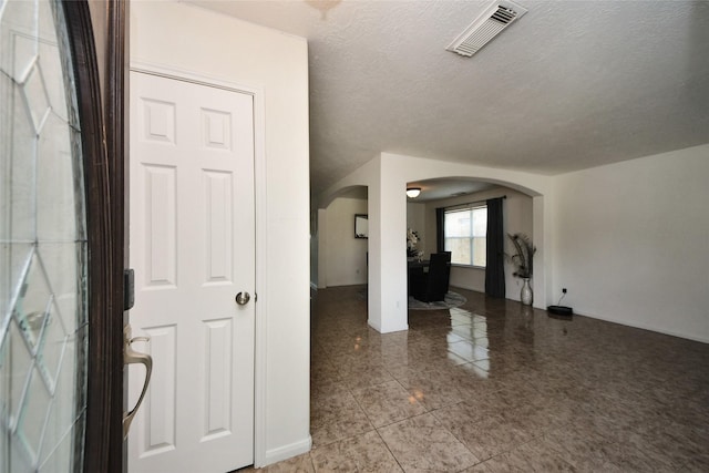 9107 S Ferndale Place Dr, Houston, TX 77064 - tiled entryway featuring arched walkways and a textured ceiling