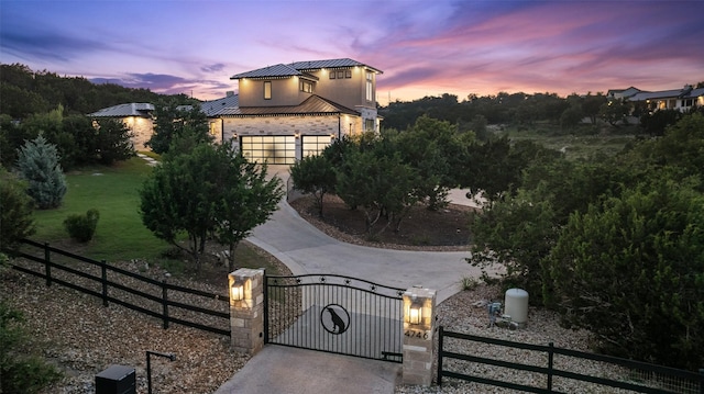 4810 R O Dr, Spicewood, TX 78669 - view of front of house featuring a standing seam roof, a fenced front yard, metal roof, and a gate