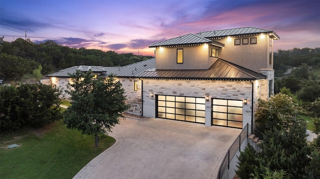 4810 R O Dr, Spicewood, TX 78669 - view of front of home with a standing seam roof, stone siding, driveway, metal roof, and stucco siding