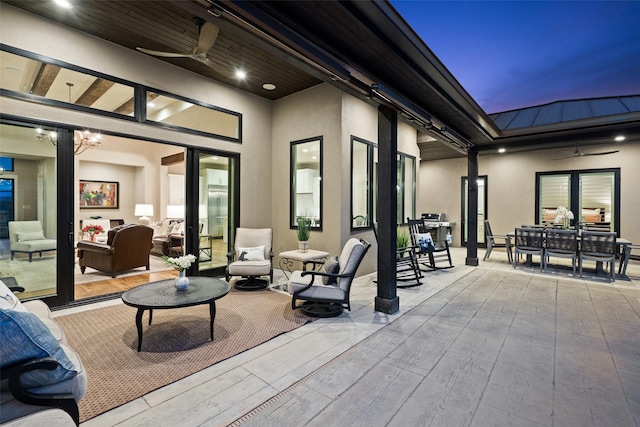 4810 R O Dr, Spicewood, TX 78669 - patio terrace at dusk featuring ceiling fan, an outdoor living space, and outdoor dining space