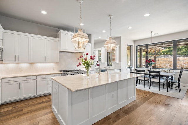 4810 R O Dr, Spicewood, TX 78669 - kitchen featuring a sink, white cabinets, hardwood / wood-style flooring, backsplash, and recessed lighting