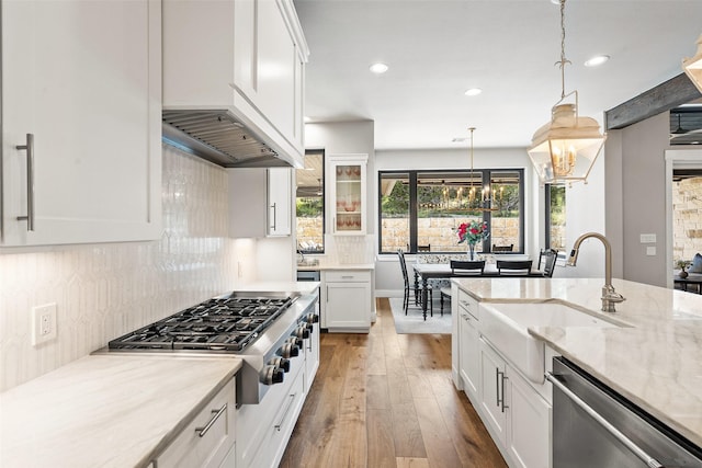 4810 R O Dr, Spicewood, TX 78669 - kitchen featuring appliances with stainless steel finishes, hardwood / wood-style floors, a sink, recessed lighting, and white cabinetry