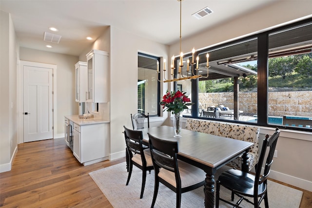 4810 R O Dr, Spicewood, TX 78669 - dining area featuring baseboards, light wood-type flooring, a chandelier, and recessed lighting