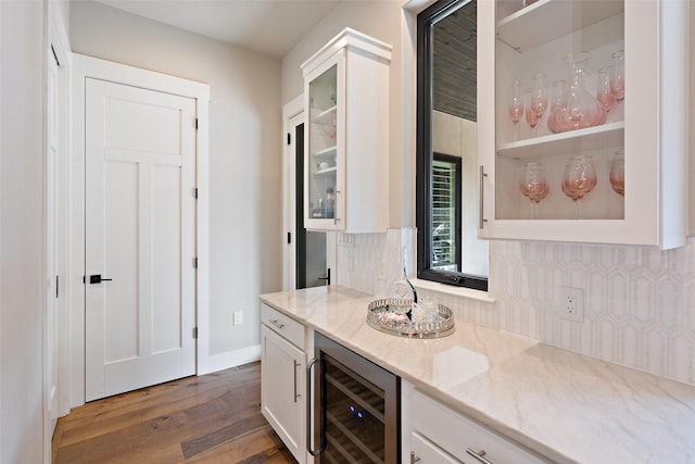 4810 R O Dr, Spicewood, TX 78669 - bar area featuring wine cooler, dark wood finished floors, backsplash, and baseboards