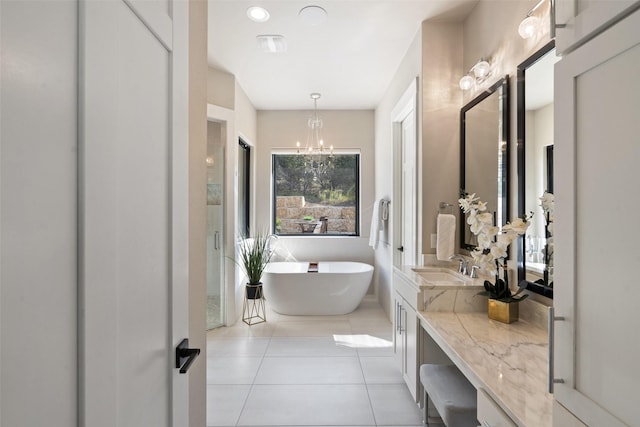 4810 R O Dr, Spicewood, TX 78669 - full bath with a chandelier, vanity, tile patterned flooring, and a freestanding tub