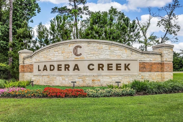 3074 Mallorca Dr, Conroe, TX 77301 - community / neighborhood sign with a lawn