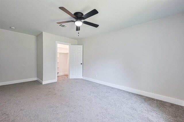 5032 Briscoe St, Houston, TX 77033 - unfurnished bedroom featuring baseboards, carpet floors, a walk in closet, and a ceiling fan