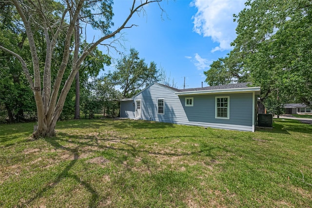 5032 Briscoe St, Houston, TX 77033 - rear view of property with a lawn and central AC unit