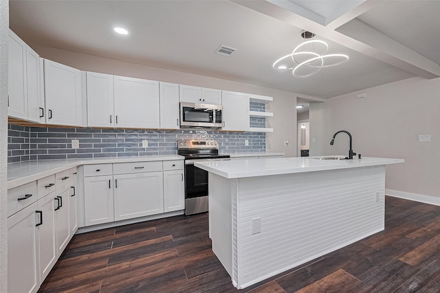 5032 Briscoe St, Houston, TX 77033 - kitchen with appliances with stainless steel finishes, a sink, light countertops, dark wood-style floors, and recessed lighting