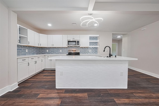 5032 Briscoe St, Houston, TX 77033 - kitchen with appliances with stainless steel finishes, a sink, open shelves, light countertops, and recessed lighting