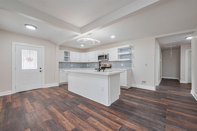 5032 Briscoe St, Houston, TX 77033 - kitchen with stainless steel appliances, open shelves, light countertops, baseboards, and recessed lighting